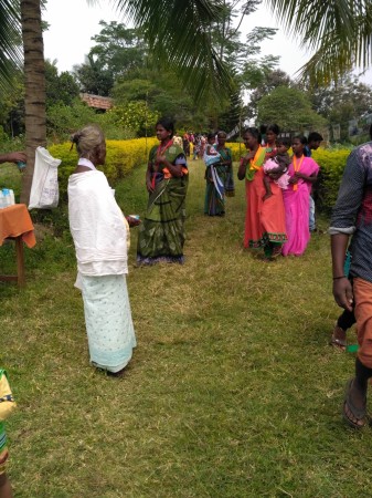 Adivasi women are seen wearing sarees and kurtis while an older woman dresses in traditional attire Tribal life