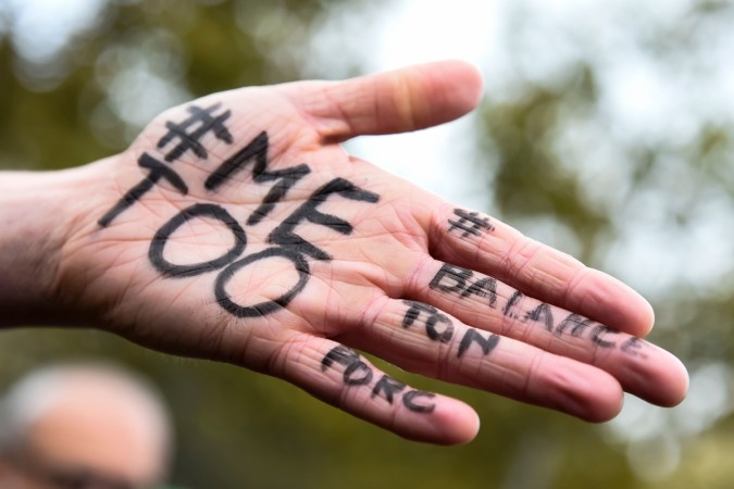 A picture shows the messages '#Me too' and #Balancetonporc ('expose your pig') on the hand of a protester #Me too