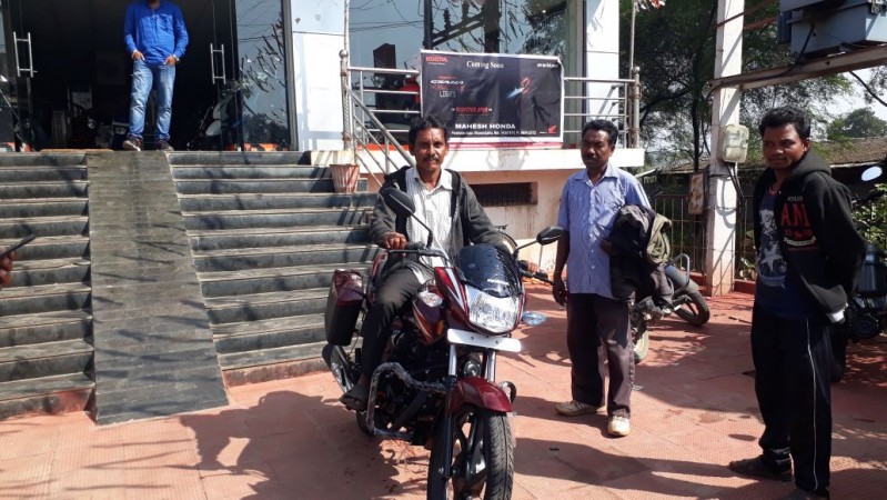 Dana Majhi, the tribal from Melghar in Odisha, poses with his new bike Dana Majhi