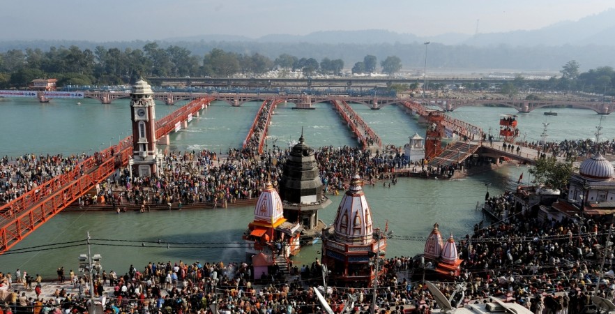 Hindu devotees gather to offer prayers during the solar eclipse on the banks of river Ganges in Haridwar on January 15, 2010, during the Kumbh Mela festival (Pitcher festival). Kumbh Mela