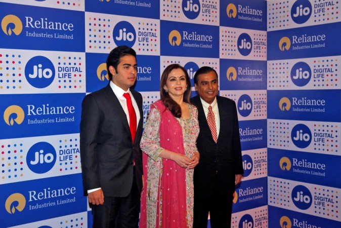 Mukesh Ambani (R), chairman of Reliance Industries Ltd, poses with his wife Nita (C) and son Akash Ambani Akash Ambani