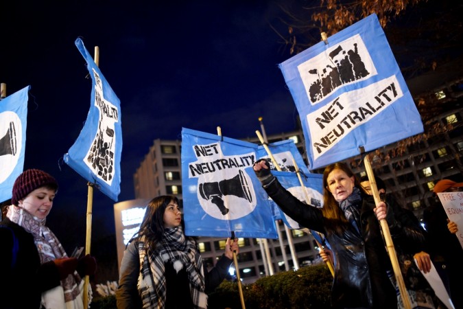 A small group of protestors supporting net neutrality protest against a plan by Federal Communications Commission (FCC) head Ajit Pai, during a protest on December 7, 2017 in Washington. Demonstrations in support of net neutrality are planned nation-wide at hundreds of Verizon stores and other venues. net neutrality