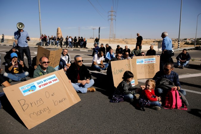 Worker of Teva Pharmaceutical Industries block a road during a demonstration near the facility in Neot Hovav, southern Israel December 17, 2017. Teva