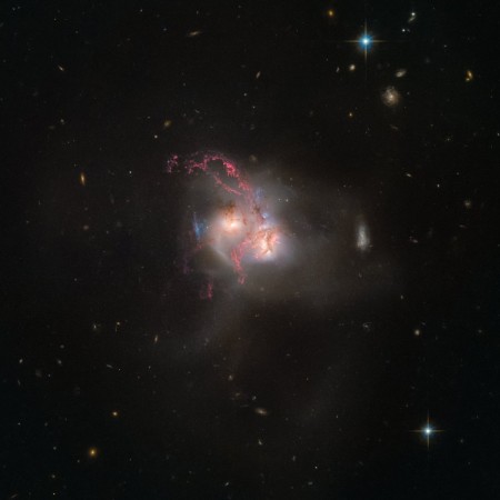 The Hubble Space Telescope captured an amazing image portraying two galaxies colliding 350 million light-years away from Earth. galaxy NGC 5256, galaxy, ESA,