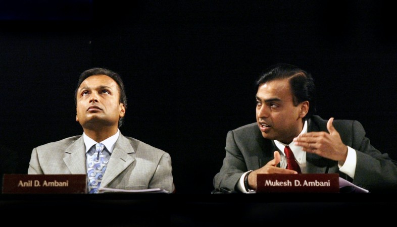 Reliance Industries Chairman Mukesh Ambani speaks as his brother Anil Ambani watches in 2004. Reliance Jio's rival Bharti Airtel's bid for defunct Reliance Communications may further intensify the telco wars. Ambani's brothers
