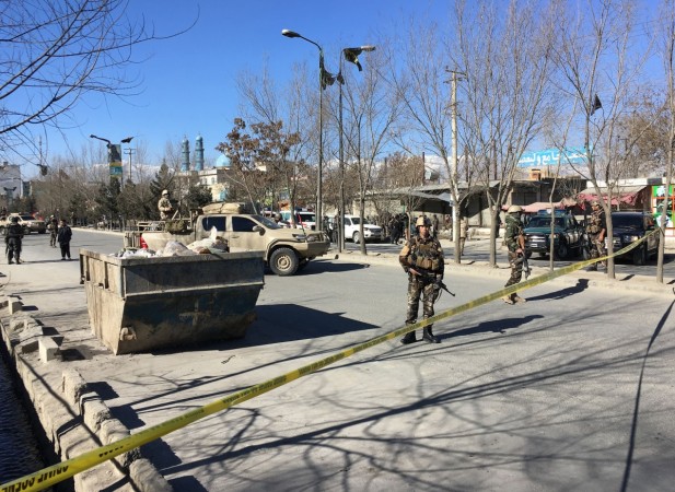 Afghan security forces stand guard near the site of multiple blasts in Kabul on December 28, 2017. Kabul blast