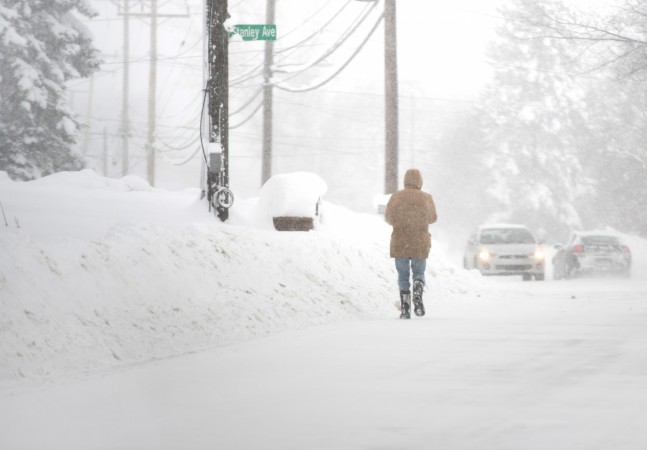 A resident walks north on Pine Ave as more snow falls after two days of record-breaking snowfall in Erie, Pennsylvania Erie Pennsylvania