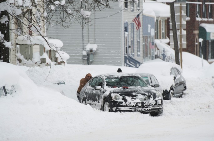 People help dig out a car from a parking spot after two days of record-breaking snowfall in Erie, Pennsylvania, U.S. Erie Pennsylvania