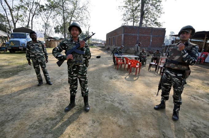 Central Reserve Police Force personnel stand guard at a temporary camp ahead of the publication of the first draft of the National Register of Citizens Assam