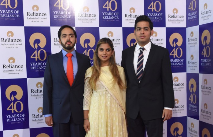 (L-R) Anant Ambani, Isha Ambani and Akash Ambani -- children of India's richest man and oil-to-telecom conglomerate Reliance Industries chairman Mukesh Ambani -- arrive for the company's 40th AGM in Mumbai on July 21, 2017. Ambani's children