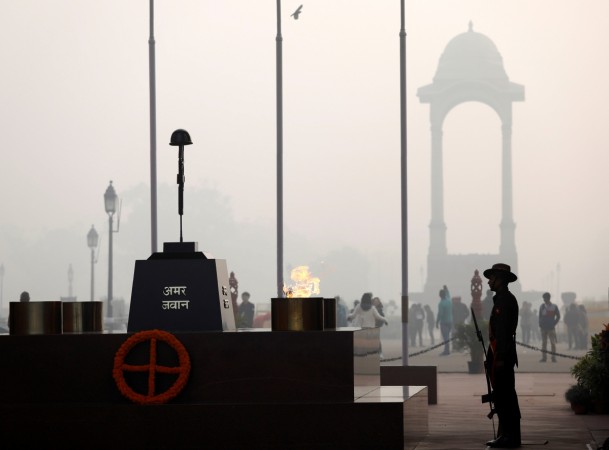 A soldier stands guard next to Amar Jawan Jyoti at the India Gate war memorial on a smoggy winter morning in New Delhi Amar Jyoti Jawan