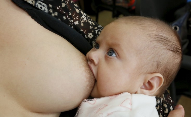 A mother breastfeeds her child together with other women during a flash mob at a children's polyclinic in the Siberian city of Krasnoyarsk, Russia. Breastfeeding