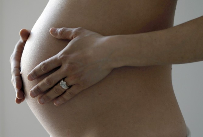 A pregnant woman, in the last trimester of her pregnancy, poses in this illustration photo in Sete, South France. Pregnancy
