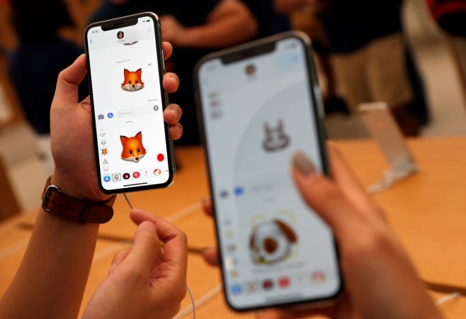 People try out the Animoji feature on iPhone X handsets during its launch at the Apple store in Singapore November 3, 2017. iPhone X