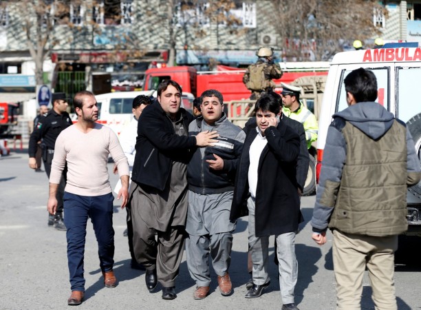 People assist an injured man after a blast in Kabul, Afghanistan January 27, 2018 Kabul