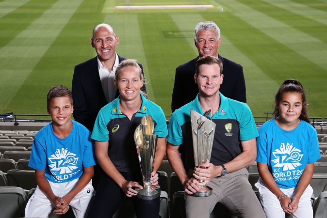 Nick Hockley, WT20 2020 LOC CEO, and David Richardson, ICC CEO, pose above Australian Cricket captains Meg Lanning and Steve Smith with the ICC T20 World Cup Trophies during the ICC World T20 media opportunity at on January 30, 2018 in Melbourne, Australia. ICC World T20 2020