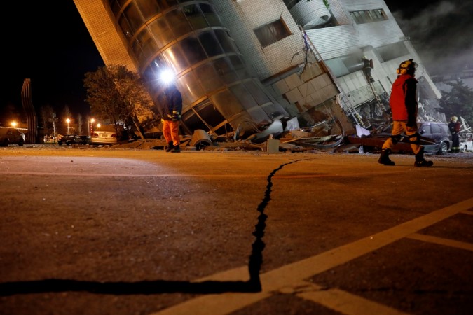 Rescue personnel search a collapses building after an earthquake hit Hualien, Taiwan February 7, 2018 Taiwan