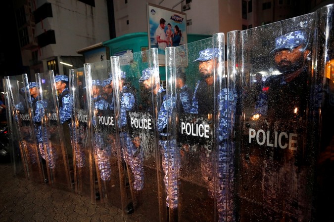Maldivian police stand guard on a main street during a protest by opposition supporters against the government's delay in releasing their jailed leaders Maldives