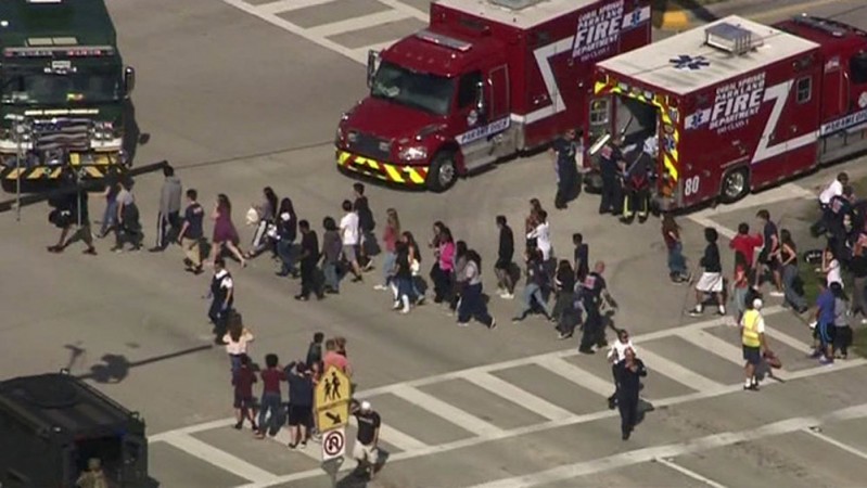Students are evacuated from Marjory Stoneman Douglas High School during a shooting incident in Parkland, Florida, February 14, 2018 in a still image from video. Florida school shooting