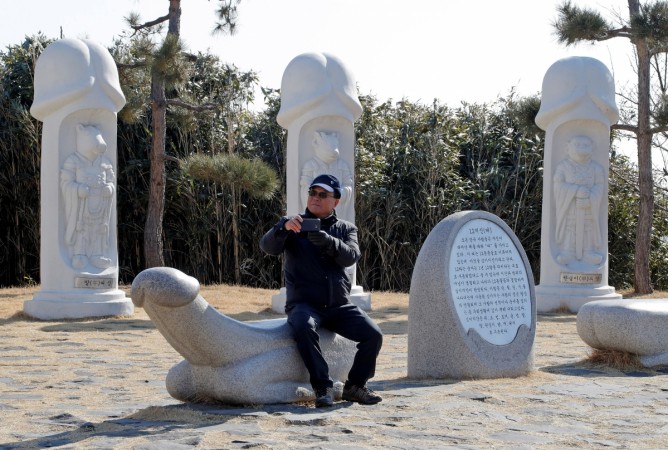 A visitor takes a photo of statues in South Korea's Haeshindang Park, also know as A visitor takes a photo of statues in South Korea's Haeshindang Park, also know as