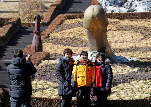 Tourists pose near a statue in South Korea's Haeshindang Park, also know as Tourists pose near a statue in South Korea's Haeshindang Park, also know as