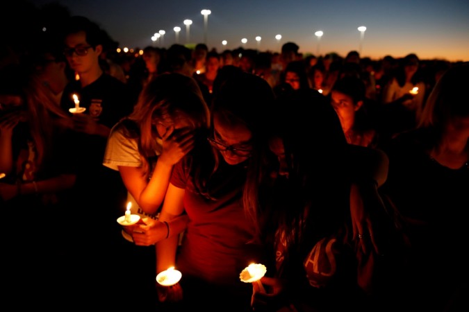 Participants hold candles for victims of the shooting in Parkland, Florida, during a candlelight vigil. florida