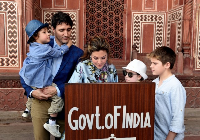 Prime Minister of Canada Justin Trudeau, his wife Sophie Gregoire and their children write on the visitors book during their visit to Taj Mahal in Agra on February 18, 2018. Hadrien Trudeau, son of Canadian Prime Minister Justin Trudeau