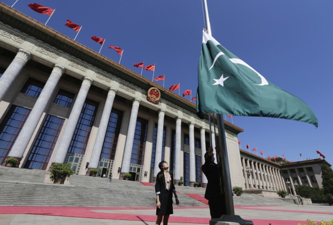 The Pakistan government approved a motion making Mandarin an official language in the country. In picture: A staff member raises Pakistan's flag in front of the Great Hall of the People Mandarin in pakistan