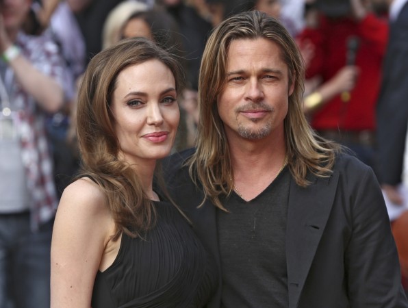 Angelina Jolie poses with her fiance Brad Pitt while they arrive for the world premiere of her World War Z movie