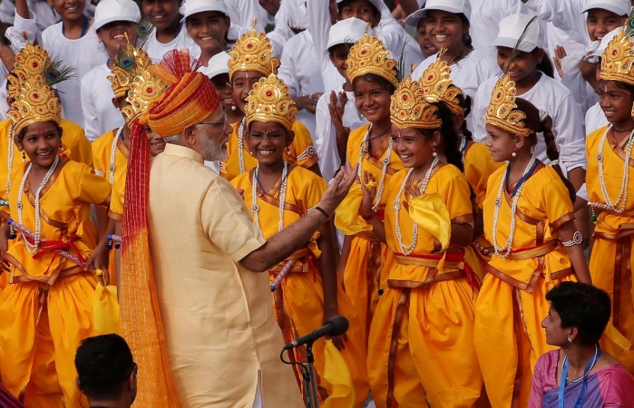 Indian Prime Minister Narendra Modi greets school girls in New Delhi. modi