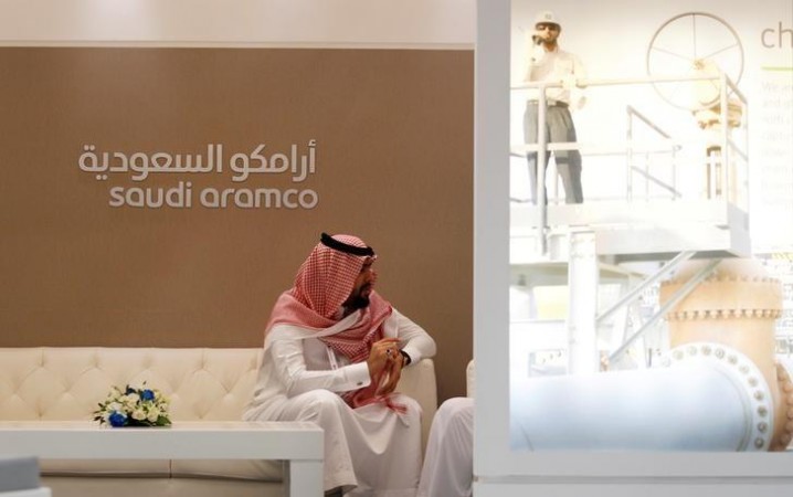 A Saudi Aramco employee sits in the area of its stand at the Middle East Petrotech 2016. Aramco