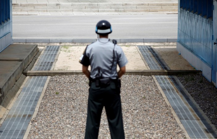 A security official stands guard at the border. north korea border
