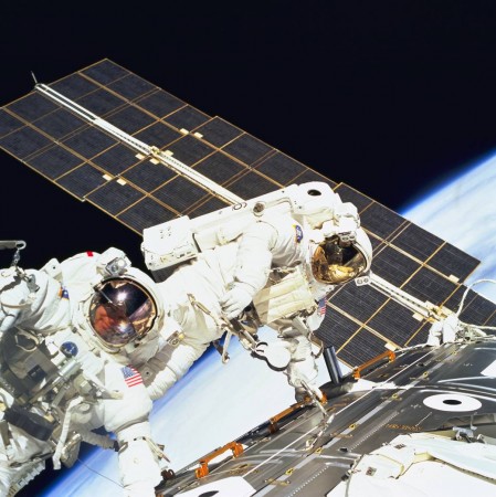 STS088-702-024 -- Astronauts Jerry L. Ross (left) and James H. Newman, both mission specialists, work together on the final of three spacewalks of the STS-88 mission. One of the solar panels of the Russian-built Zarya module runs through the frame. STS088-702-024 -- Astronauts Jerry L. Ross (left) and James H. Newman, both mission specialists, work together on the final of three space walks of the STS-88 mission. One of the solar panels of the Russian-built Zarya module runs through the frame.