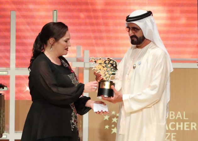 British teacher Andria Zafirakou receives the 'Global Teacher Prize' from Sheikh Mohammed bin Rashid al-Maktoum, Vice-President and Prime Minister of the UAE and Ruler of Dubai during an award ceremony in Dubai on March 18, 2018 British teacher Andria Zafirakou