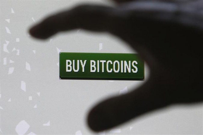 Tembusu Terminals' Andras Kristof gestures as he speaks to the media after launching the first Bitcoin vending machine at a pub in Singapore. bitcoin