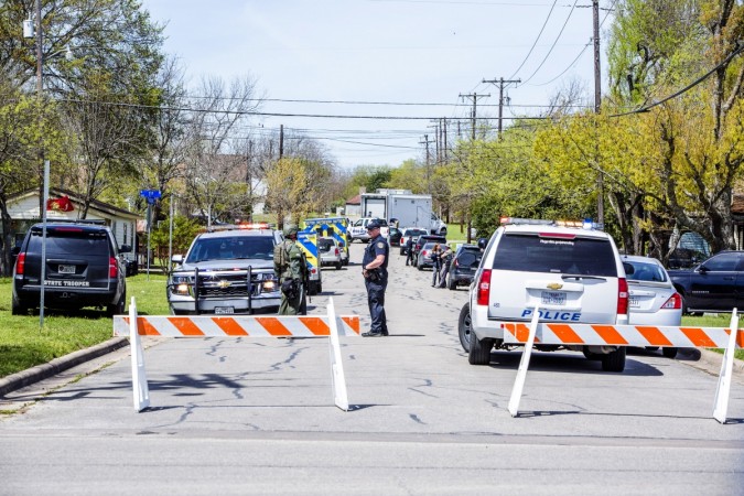 Law enforcement barricade the street as they search the home of suspected Austin bomber Mark Anthony Conditt on March 21, 2018, in Pflugerville, Texas.T he 24-year-old Conditt blew himself up inside the SUV he was driving as police tried to take him into custody. Austin Bombing