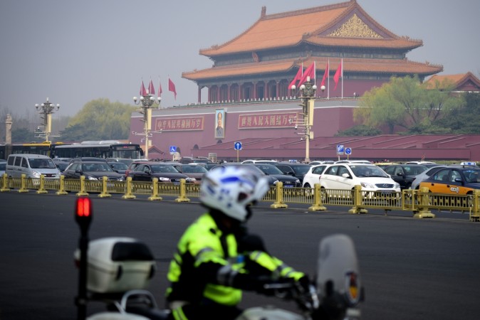 A police officer rides his motorcycle patrolling near Tiananmen Square in Beijing on March 27, 2018 Kim Jong-un in China