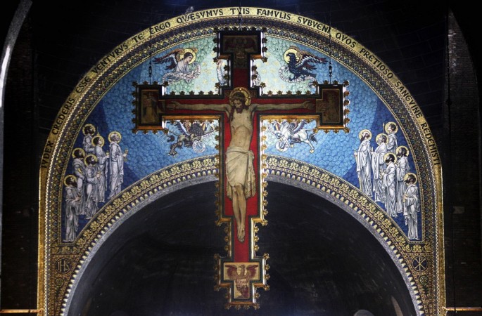 A cross with a painting of Jesus Christ hangs over the alter at Westminster Cathedral during Ash Wednesday mass on February 21, 2007 in London Jesus Christ