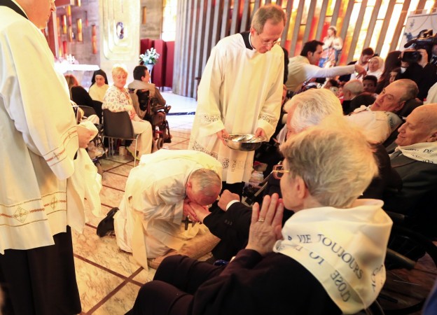 Pope Francis kisses a foot of a disabled person at the S. Maria della Provvidenza church in Rome, during the Holy Thursday celebration, April 17, 2014. Pope Francis kisses a foot of a disabled person at the S. Maria della Provvidenza church in Rome, during the Holy Thursday celebration, April 17, 2014.
