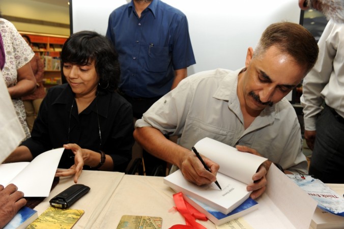 Anita Karwal and her husband signing copies of their book anita karwal