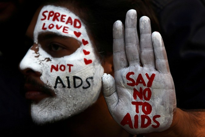 A student displays his face and hand painted with messages during an HIV/AIDS awareness campaign on the occasion of World AIDS Day HIV/AIDS