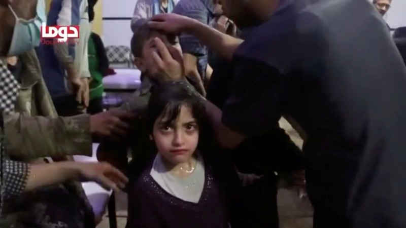 A girl looks on following alleged chemical weapons attack, in what is said to be Douma, Syria in this still image from video obtained by Reuters on April 8, 2018. Syria attack