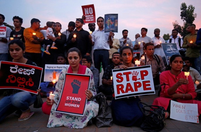 People participate in a candlelight vigil as they protest against the rape of an eight-year-old girl in Kathua near Jammu, and a teenager in Unnao, Uttar Pradesh state, in Bengaluru, India, April 13, 2018 Protests against Kathua and Unnao rape