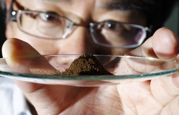 Yasuhiro Kato, an associate professor of earth science at the University of Tokyo, displays a mud sample extracted from the depths of about 4,000 metres (13,123 ft) below the Pacific ocean surface where rare earth elements were found, at his laboratory in Tokyo July 5, 2011. rae