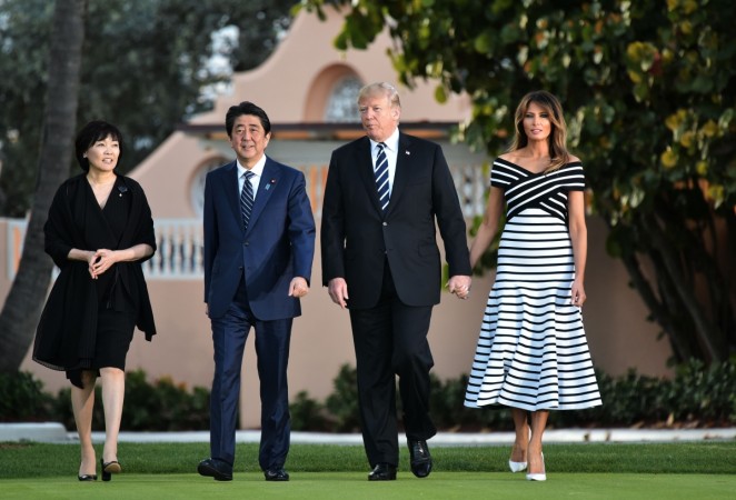 US President Donald Trump and First Lady Melania Trump walk with Japan's Prime Minister Shinzo Abe and wife Akie Abe as they arrive for dinner at Trump's Mar-a-Lago resort in Palm Beach, Florida on April 17, 2018. Melania Trump