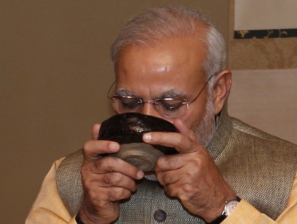 Modi sipping tea during a trip to Japan. modi sipping tea