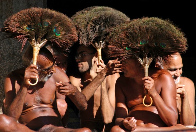 Jain monks hold peacock feathers during prayers ahead of preparations for the Mahamastak Abhisheka ceremony, in one of the most important Jain pilgrimage centres at Shravanabelagola in Karnataka Jain Monk