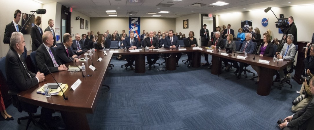 In this handout photo provided by NASA, NASA Administrator Jim Bridenstine, left, Vice President Mike Pence, and Chief Financial Officer Jeff DeWit, right, meet with NASA leadership, Monday, April 23, 2018 at NASA Headquarters in Washington. Jim Bridenstine