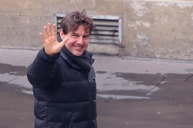 US actor Tom Cruise waves during the filming of 'Mission Impossible 6' in a Paris street on May 3, 2017. Tom Cruise