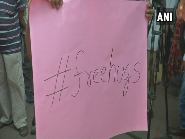 Youngsters offering free hugs to people outside Dum Dum metro station in kolkata'. free hugs